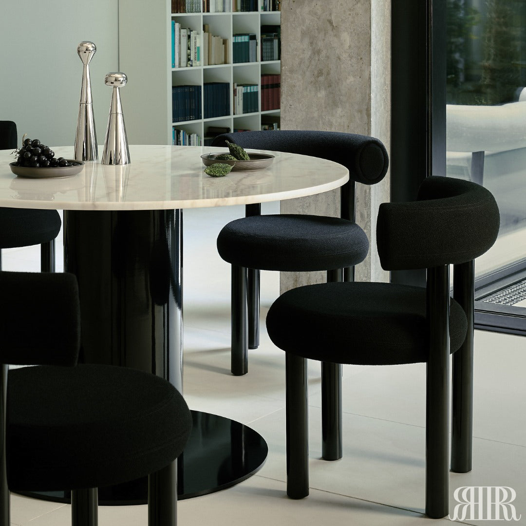 Dining table with black chairs in a modern interior setting