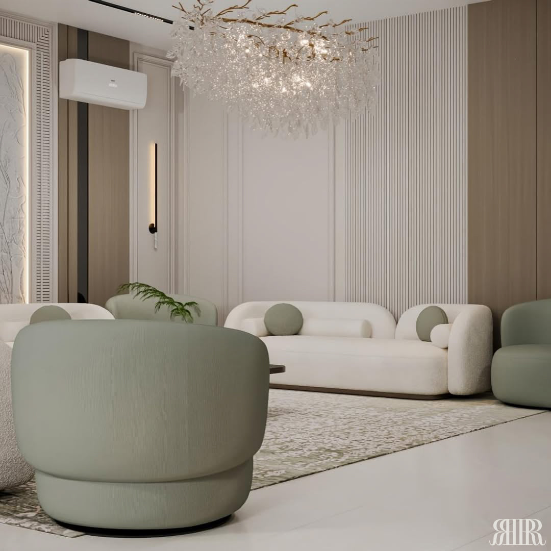 Modern living room with white sofa, green ottoman, and decorative chandelier.