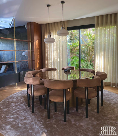 Dining area with round table and chairs in a modern interior setting.