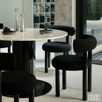 Dining table with black chairs in a modern interior setting
