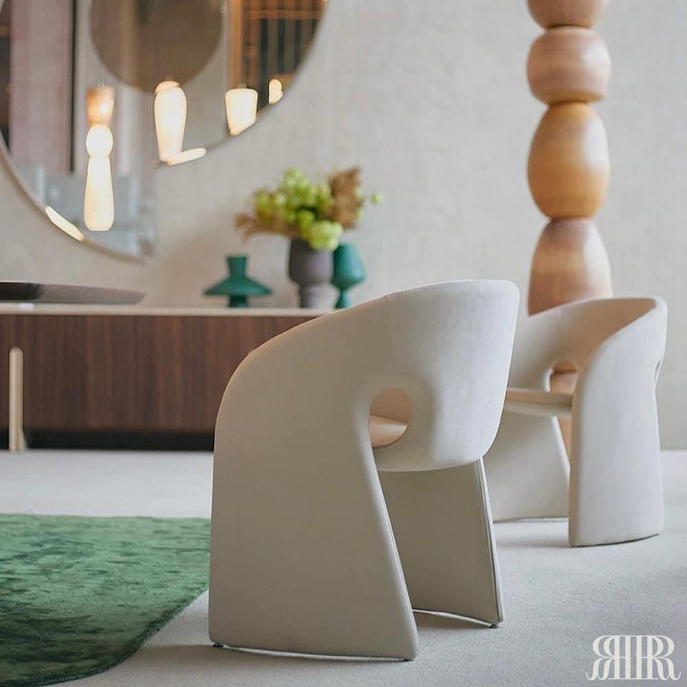Modern white chairs in a stylish room with decorative elements.
