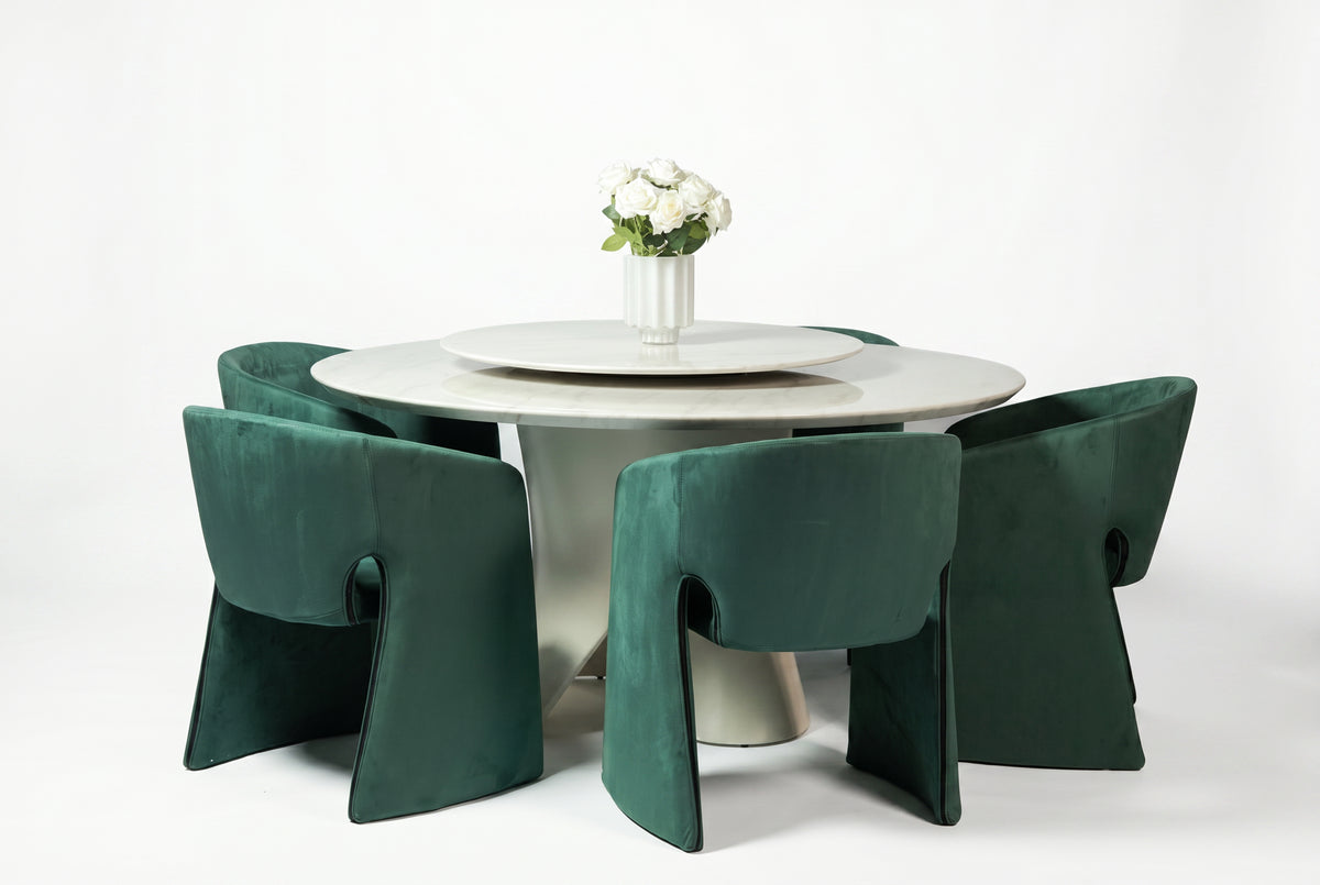 Round dining table with four green chairs on a white background