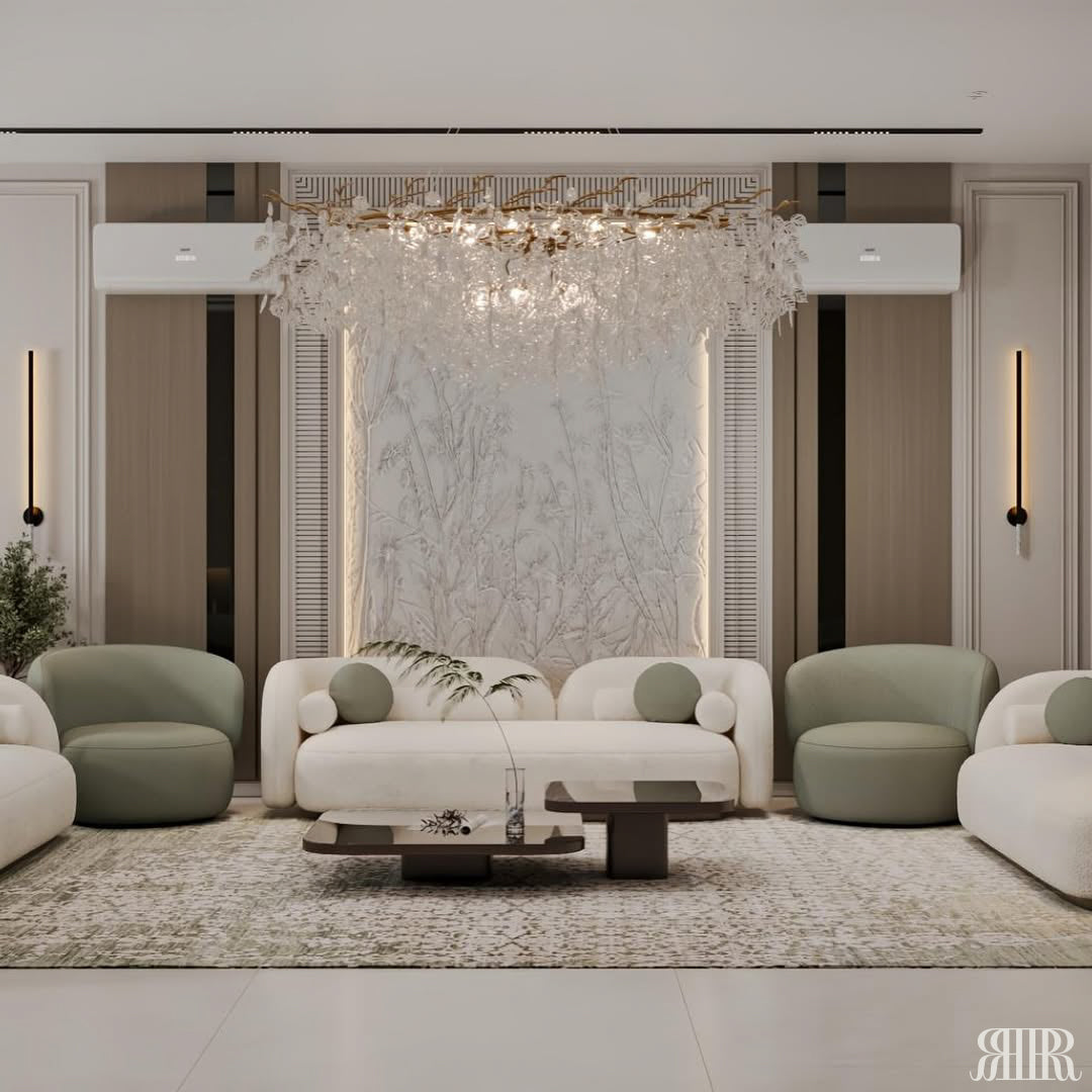 Modern living room with white sofa, green armchairs, and chandelier.