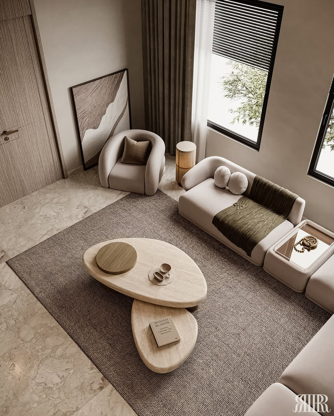 A modern living room featuring a light beige sectional sofa, a matching armchair, a large textured gray area rug, and two organic-shaped light wood coffee tables. The room has beige walls, large windows with black frames and blinds, and a framed abstract print on the floor.